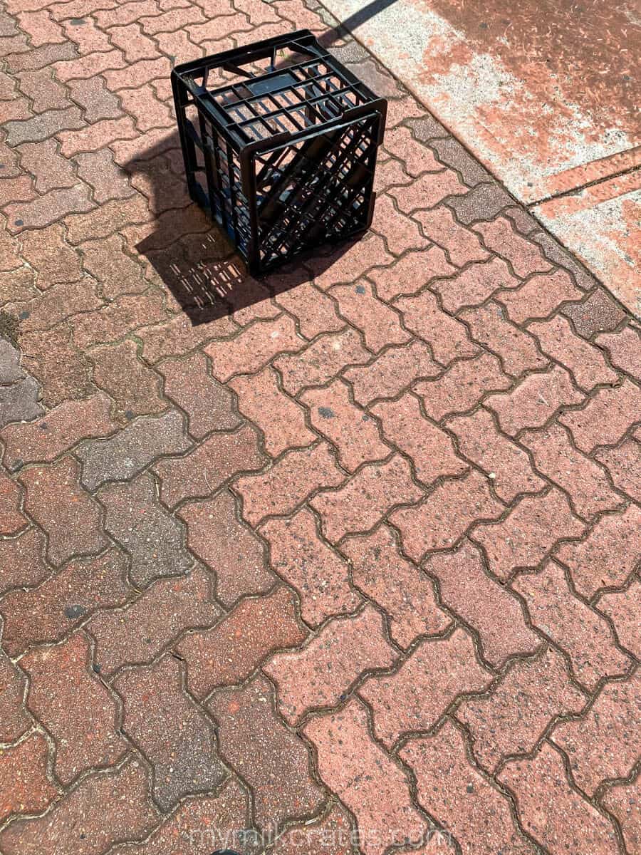 Black crate on the footpath